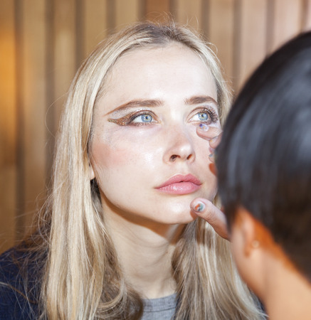 New York, NY, USA - April 15, 2016: A model prepares backstage for RIVINI & Alyne Spring 2017 Bridal Collection at The Standart, High Line during New York International Bridal week, Manhattanのeditorial素材