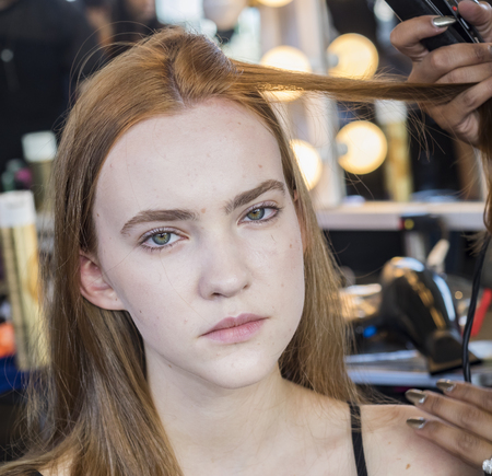 New York, NY, USA - September 11, 2016: A model prepares backstage for the Custo Barcelona women's & men's Spring/Summer 2017 runway show during New York Fashion Week SS 2017 at Pier 59 Studios at Chelsea Piers, Manhattanのeditorial素材