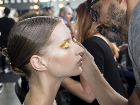 New York, NY, USA - September 11, 2016: A model prepares backstage for the Custo Barcelona women's & men's Spring/Summer 2017 runway show during New York Fashion Week SS 2017 at Pier 59 Studios at Chelsea Piers, Manhattanのeditorial素材