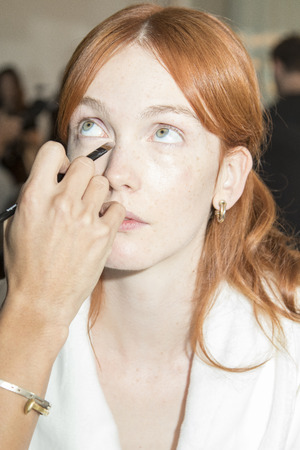 New York, NY, USA - October 5, 2016: A model prepares backstage for Marchesa Fall/Winter 2017 Bridal Presentation at Canoe Studio, Manhattanのeditorial素材