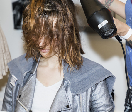 New York, NY, USA - April 21, 2017: A model prepares backstage for Monique Lhuillier Runway Bridal Show Spring/Summer 2018 during New York International Bridal Week at Weill Music Room at Carnegie Hall, Manhattanのeditorial素材