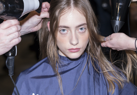 New York, NY, USA - September 7, 2017: A model prepares backstage for the Noon by Noor Spring/Summer 2018 runway show during New York Fashion Week at Skylight Clarkson Sq., Manhattanのeditorial素材
