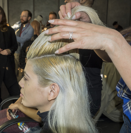 New York, NY, USA - February 5, 2018: A model Prepares backstage for Willy Chavarria Fall/Winter 2018 runway show during NY Fashion Wweek: Men's at Pier 59 Studios, Manhattanのeditorial素材