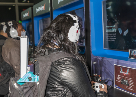 New York, NY, USA - October 4, 2018: Comic Con attendee plays computer game Devil May Cry 5 during...