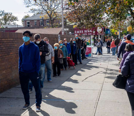 Brooklyn, NY, USA - October 27, 2020: People waiting in line for early general voting at St. Dominic's Catholic Church, Brooklyn amid coronavirus pandemic.のeditorial素材
