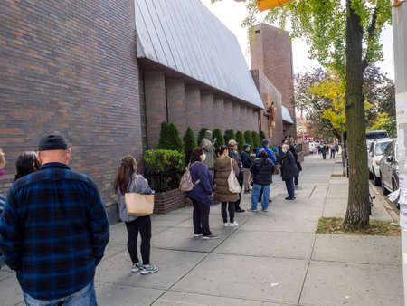 Brooklyn, NY, USA - October 27, 2020: People waiting in line for early general voting at St....