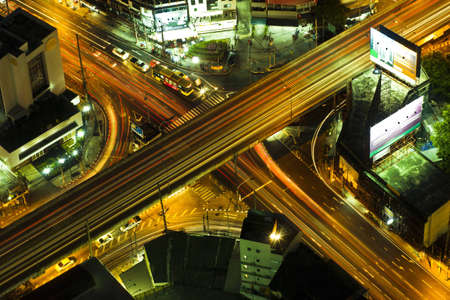 Lights on at night. In the city the car is running.