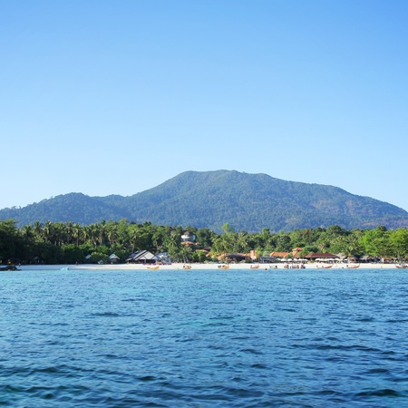 Marine attractions. The island with a resort and a long tail boat.の写真素材