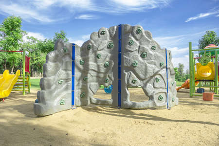 Playground Kids enjoy climbing located the sand.