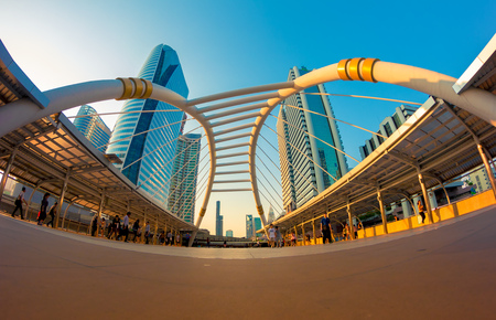 BANGKOK - Apr 21: Unidentified people walk along a skywalk in Sathorn on Apr 21, 2015 in Bangkok, Thailand. Home to international companies, Sathorn is the Thai capital's central business district.のeditorial素材