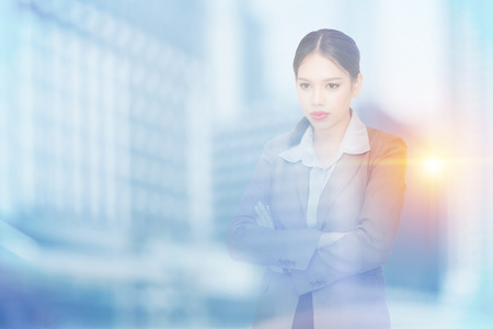 Double exposure of businesswoman and cityの写真素材