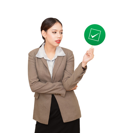 business woman is holding a checkbox, a concept of decision making process.の写真素材