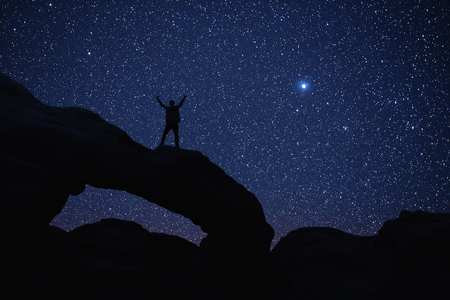 Man who feels on top of the world looking at the starの写真素材