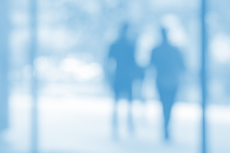 High key blurred image of people walking in the street. の写真素材