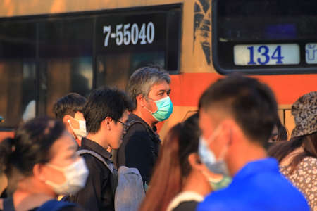 Bangkok - Thailand, 29 Feb 2020: People wearing medical masks to prevent germs. The virus makes...