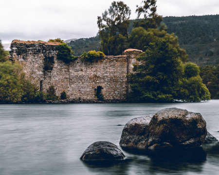 A fortress rises resolutely from the heart of a pristine lake, standing as a sentinel of history and strength. Surrounded by shimmering waters, this majestic stronghold commands attention, evoking a sense of intrigue and wonder as it stands steadfast in its watery domain.の写真素材