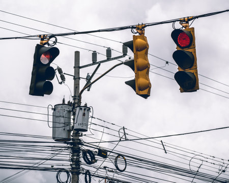 Suspended red traffic lights illuminate the scene, casting a captivating glow. The vibrant hues blend with the urban ambiance creating a visually striking composition that captures the essence of the cityの写真素材