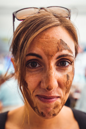 A young woman's portrait, clay delicately gracing her face, radiates her artistic essence. A captivating fusion of beauty and creativity, showcasing the transformative power of artの写真素材