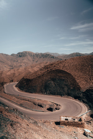 Curving through Atlas mountains, an intricate road winds, revealing the untamed beauty of the rugged terrain, promising an unforgettable adventure.の写真素材