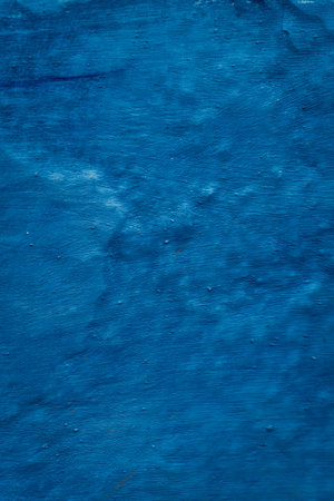 Vibrant blue wall texture: A captivating textured surface in striking blue, adding depth and character to any setting.の写真素材