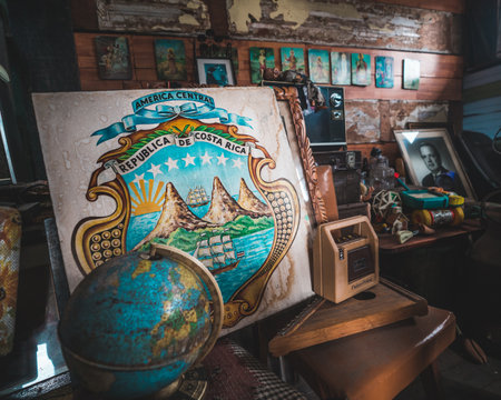 Antique shop filled with various treasures. Costa Rica emblem framed, reflecting rich heritage amidst the eclectic array of items. A nostalgic journey through time.のeditorial素材