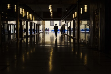 Business silhouette in tunnel, reflection and lights, Milano, Italyの写真素材