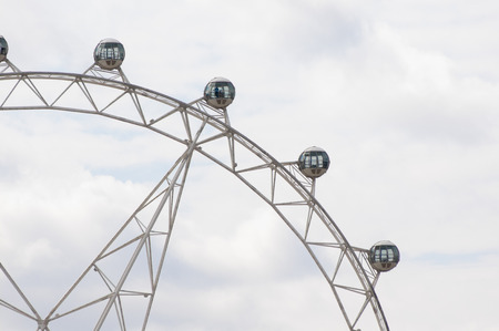 Ferris Wheel Cabins in-front of a Cloudy Skyの写真素材