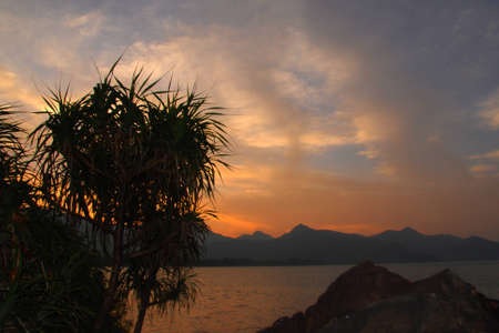 Dawn landscape with the sea and mountainsの写真素材