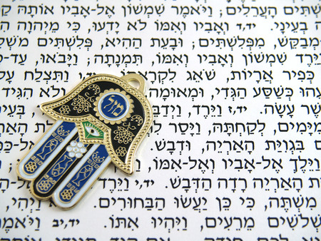 Hamsa kabbalah good luck charm on Hebrew bibleの写真素材