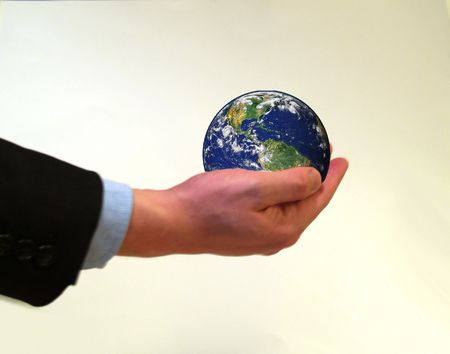 Businessman holding planet earth in his handの写真素材