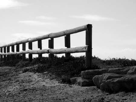 Old wooden log fence with sky background - bwの写真素材