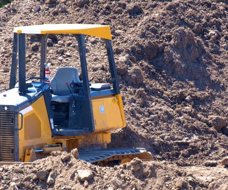 Large yellow bulldozer in construction site