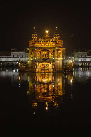 Golden Temple in Amritsar India reflected on waterの写真素材