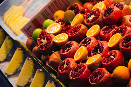 Pomegranate, oranges and pineapples on fruit stand in Istanbul, Turkeyの写真素材