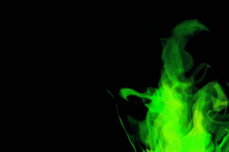 Green colour abstract oil paint flame on a black colour backgroundの写真素材
