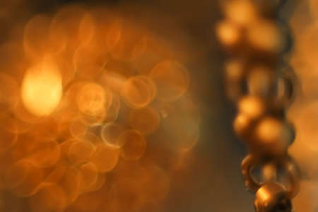 Golden bokeh pattern on yellow dark defocus background.の写真素材