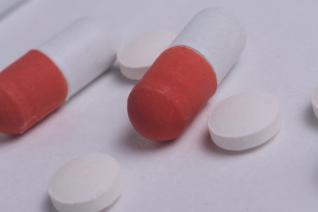 capsules and tablets in hand stock photo