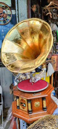 Vintage golden pocket watch on the chain in hand on rock background, time conceptのeditorial素材