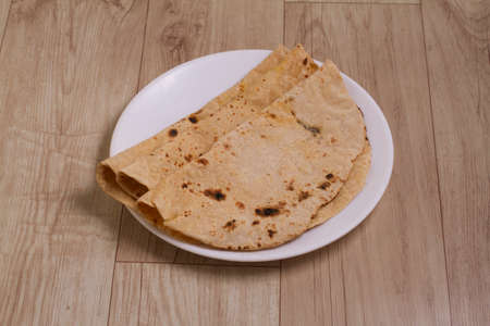 daal and chapati on a wooden background. selective focus.