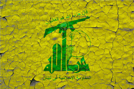 Hezbollah flags painted over cracked concrete wallの写真素材