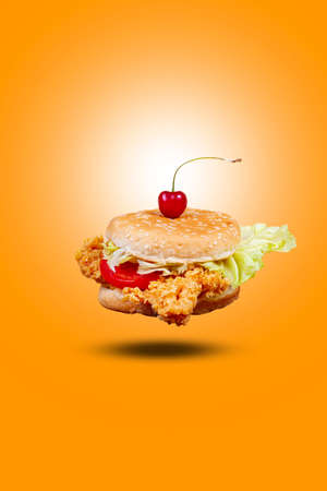 Juicy flying fish burger, hamburger or cheeseburger with one fish patties. Concept of American fast food. Copy spaceの写真素材