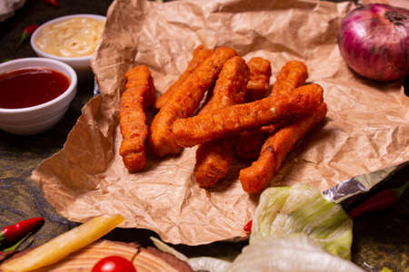 crispy fried chicken fingers with Ketchup on wooden boardの写真素材