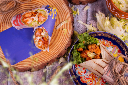 Fresh sausage roll with fresh tomatos, salad, cheese and onions isolated on bright blue background....
