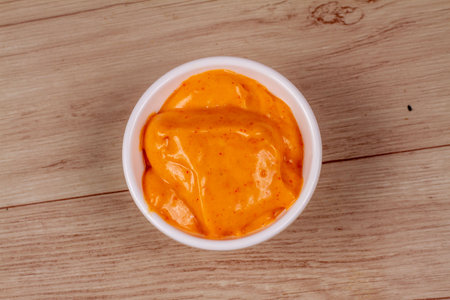 White Bowl of tasty chipotle sauce on wooden backgroundの写真素材