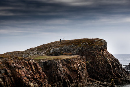 Couple standing on a cliff in the north of Scotland, UK