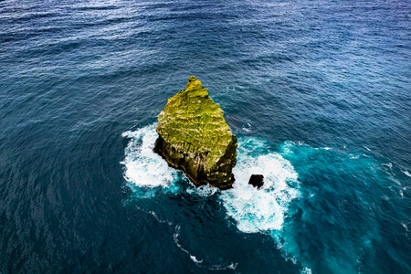 Aerial view of a cliff in the middle of the sea.