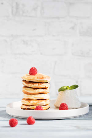 Stack of ricotta-pancake with raspberries, honeyの写真素材