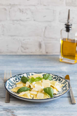 Cooked ravioli with ricotta and basil, on a light backgroundの写真素材