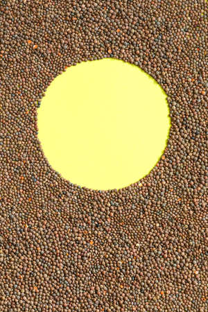 Brown lentil background with yellow circle copy space