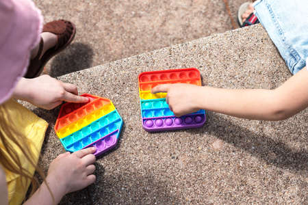 Two children play anti-stress toy    on the streetの写真素材